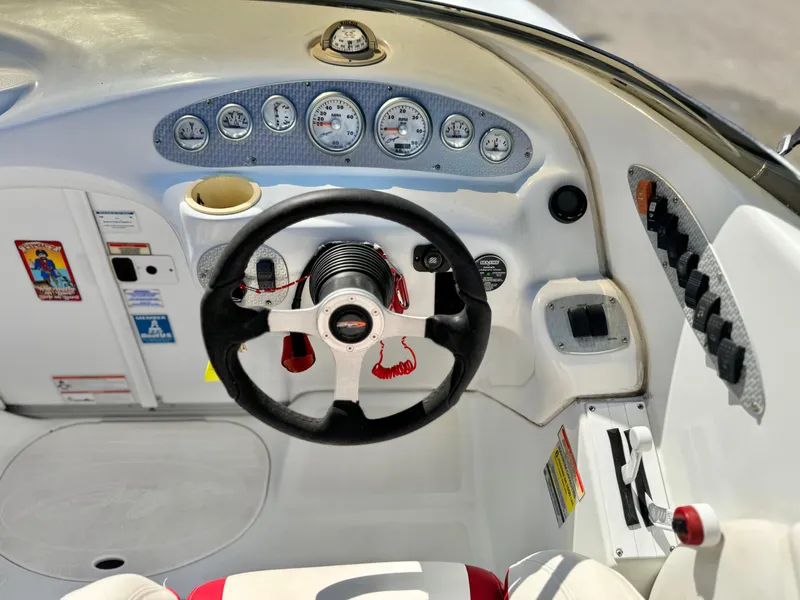Slide: The Image of Cockpit of 2002 Baja 24H2X boat with steering wheel and instrument panel. - 23