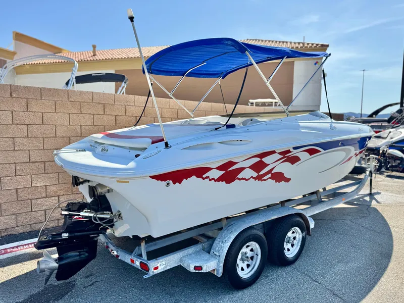 Slide: The Image of 2002 Baja 24H2X speedboat with red graphics, blue canopy, on a dual-axle trailer. - 5