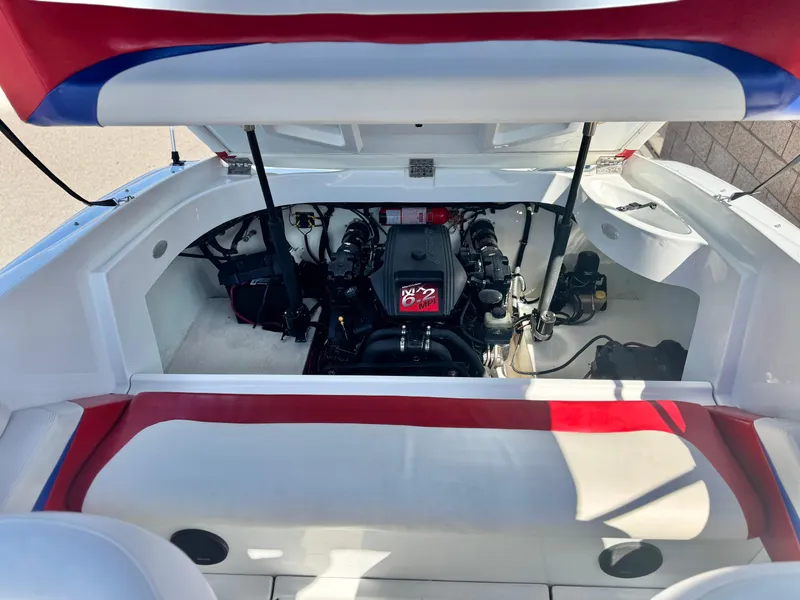 Slide: The Image of 2002 Baja 24H2X boat engine compartment with open hatch, showcasing engine and interior details. - 11