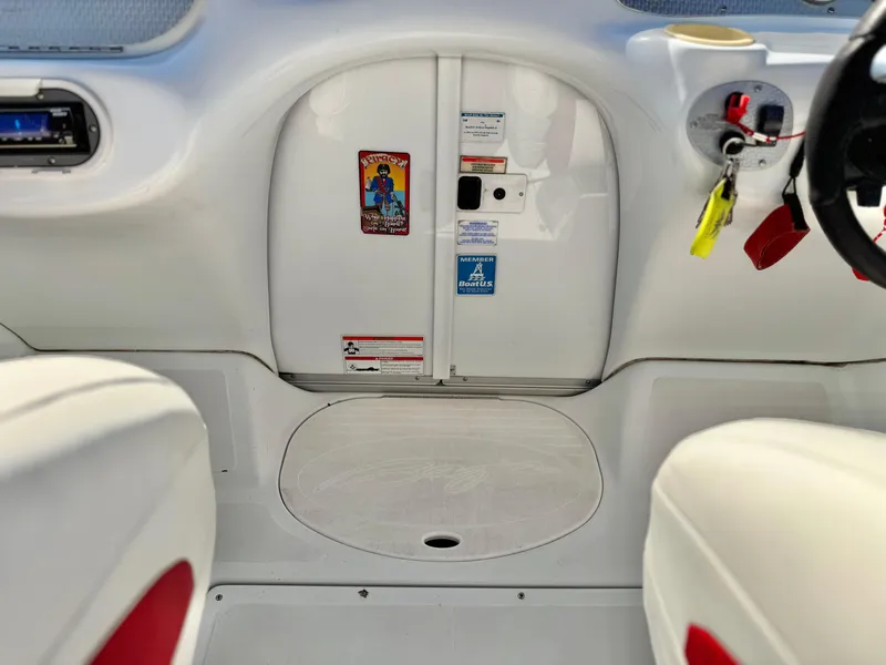 Slide: The Image of 2002 Baja 24H2X boat interior with white seating and dashboard controls. - 15