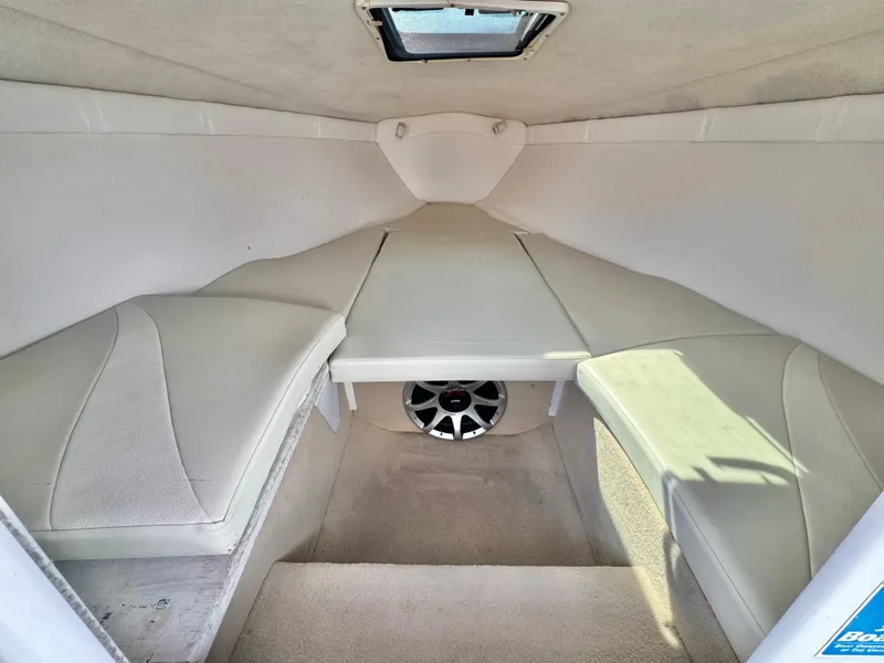 Slide: The Image of 2002 Baja 24H2X boat cabin interior with white upholstery and speaker. - 17