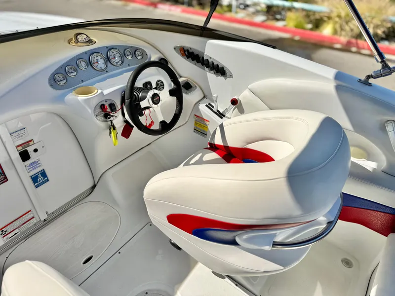 Slide: The Image of Interior of a 2002 Baja 24H2X boat with steering wheel and gauges. - 22