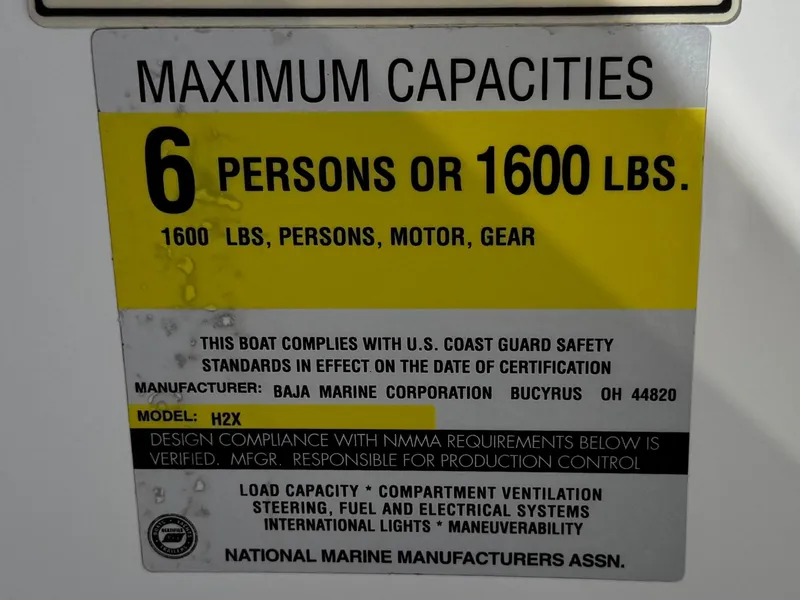 Slide: The Image of 2002 Baja 24H2X boat capacity label: 6 persons or 1600 lbs, U.S. Coast Guard compliant. - 27