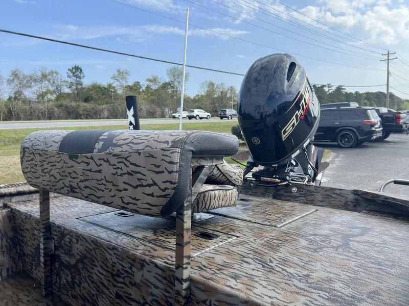 Slide: The Image of 2025 Xpress XP18CC boat with camouflage design and powerful outboard motor. - 11