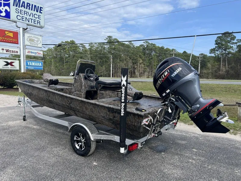 Slide: The Image of 2025 Xpress XP18CC boat with Yamaha engine at marine service center. - 4