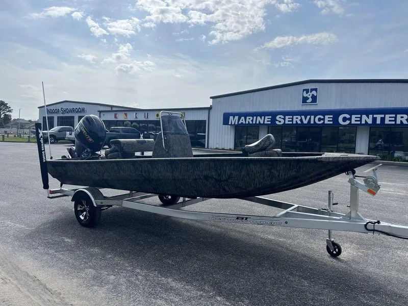Slide: The Image of 2025 Xpress XP18CC boat on trailer at marine service center. - 5
