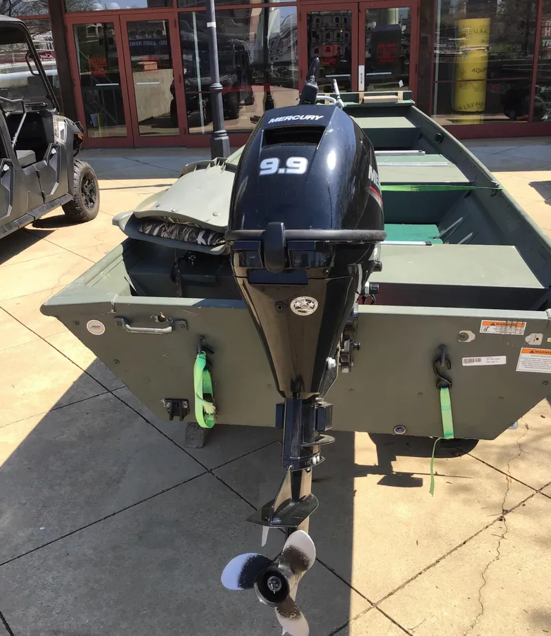 Slide: The Image of 2021 Gamefisherman 14 boat with 9.9 horsepower outboard motor, displayed outdoors. - 4