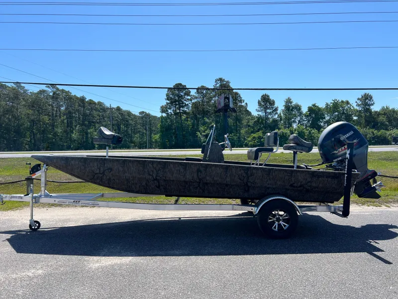 Slide: The Image of 2025 Xpress XP20CC boat on trailer, parked outdoors, side view. - 1