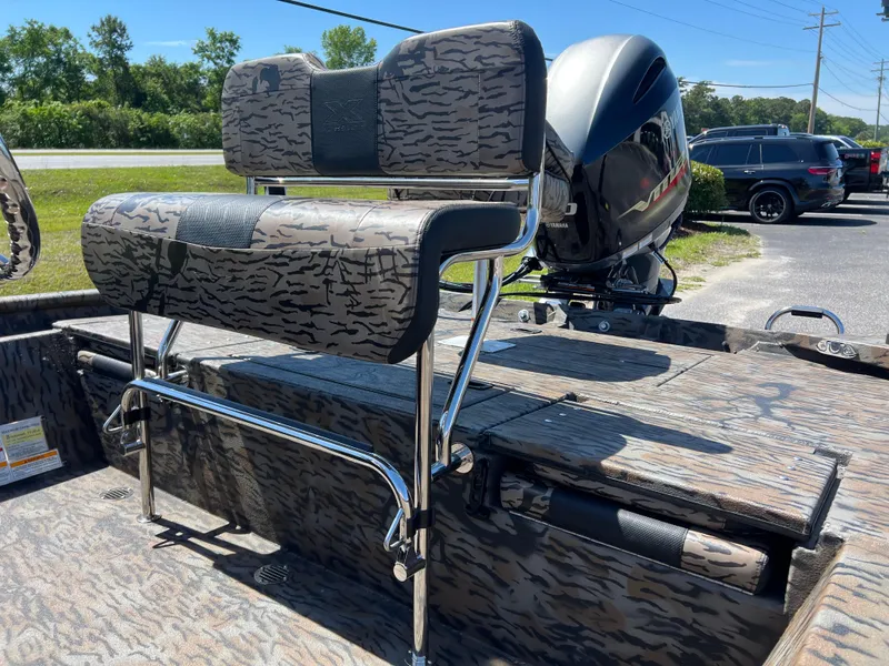 Slide: The Image of 2025 Xpress XP20CC boat with camo seating and powerful outboard motor. - 10
