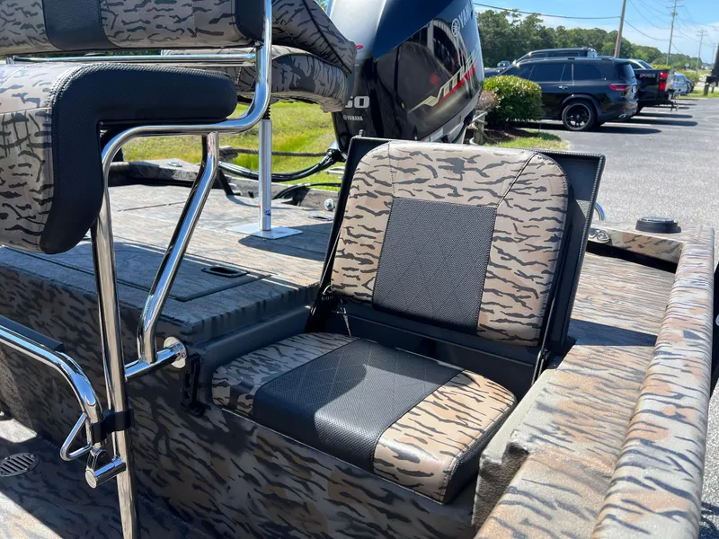 Slide: The Image of 2025 Xpress XP20CC boat interior with camo-patterned seating and chrome accents. - 11