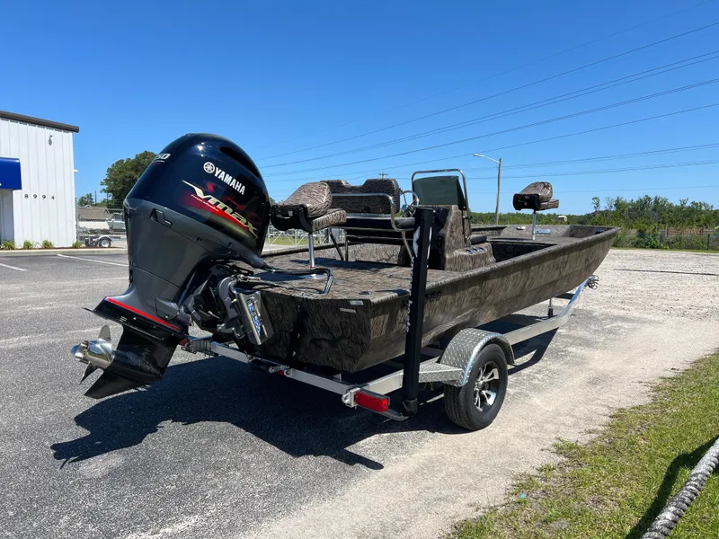Slide: The Image of 2025 Xpress XP20CC boat with Yamaha outboard motor on trailer, parked outdoors. - 6