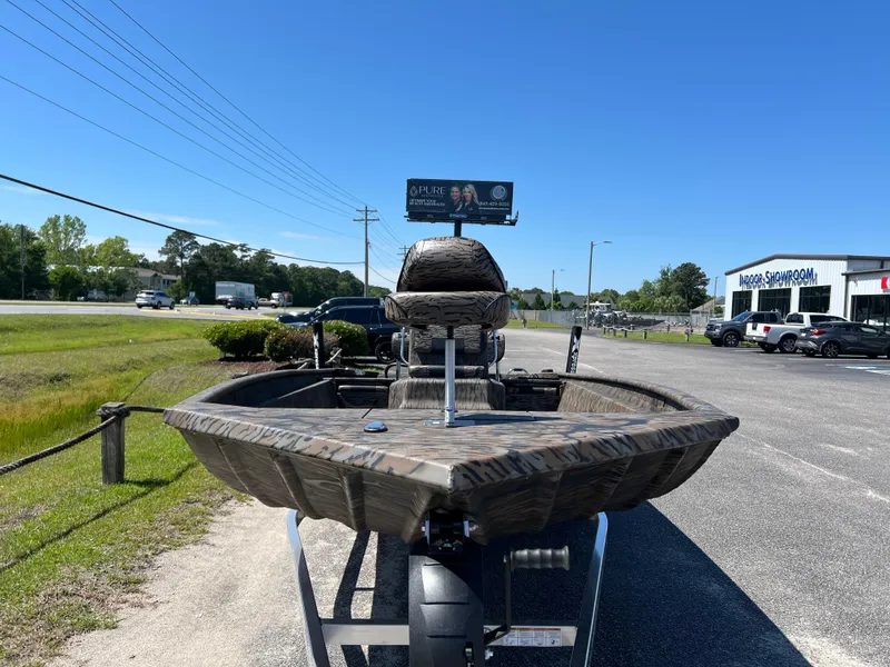Slide: The Image of 2025 Xpress XP20CC boat on trailer in parking lot, sunny day. - 7