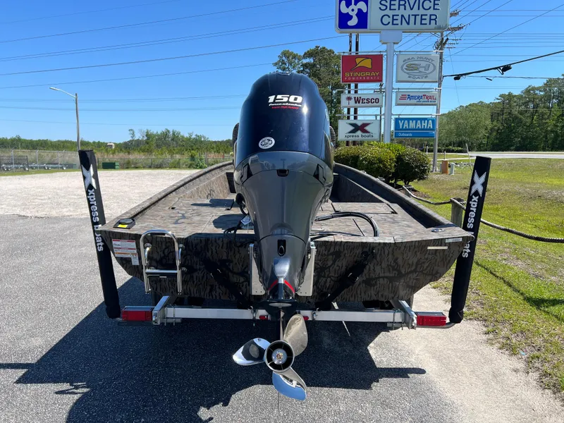 Slide: The Image of 2025 Xpress XP20CC boat with 150 HP engine at service center. - 8