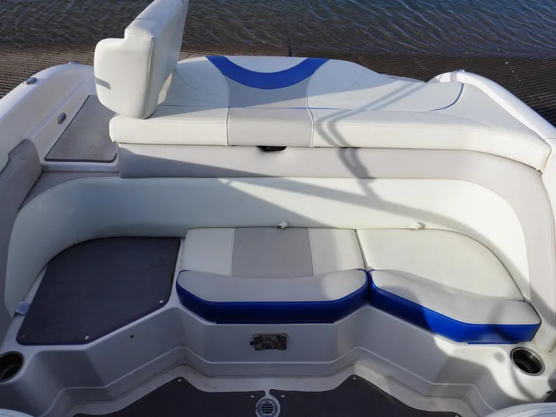 Slide: The Image of Interior seating of a 2013 Bryant 220 boat with white and blue upholstery. - 12