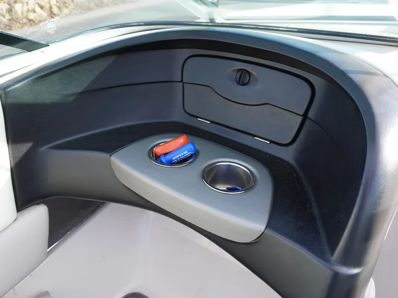 Slide: The Image of Dashboard storage area in a 2013 Bryant 220 boat with cup holder and compartment. - 14