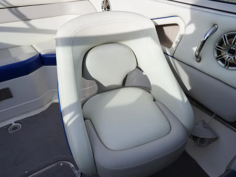 Slide: The Image of Boat seat in a 2013 Bryant 220, featuring white upholstery and integrated speaker. - 15
