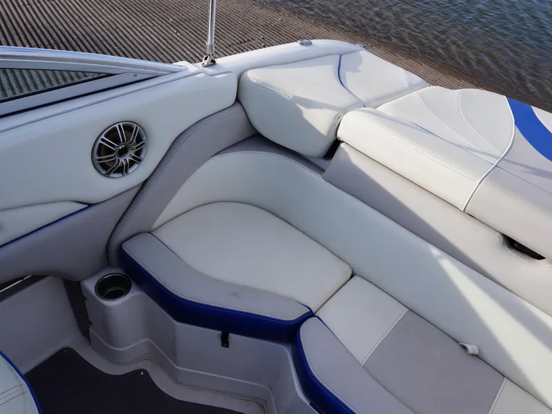 Slide: The Image of Interior seating of a 2013 Bryant 220 boat with white and blue upholstery. - 21