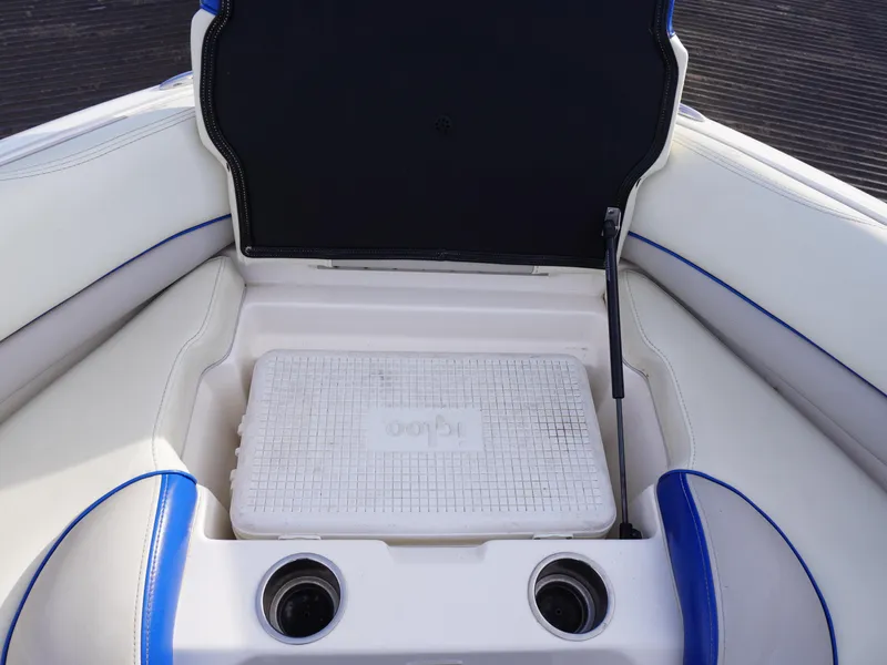Slide: The Image of 2013 Bryant 220 boat interior with cooler and cup holders. - 23
