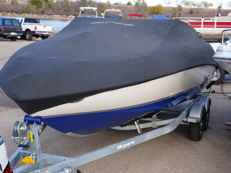 Slide: The Image of Covered 2013 Bryant 220 boat on trailer in parking lot. - 26