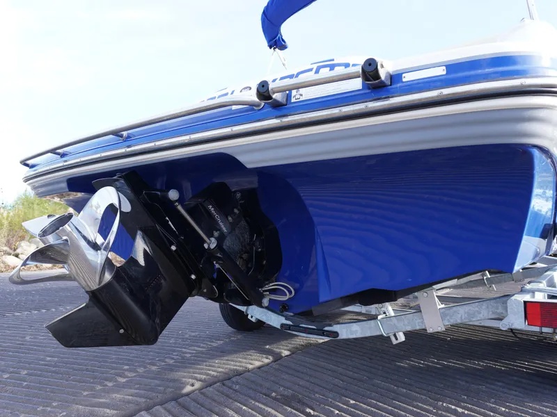 Slide: The Image of 2013 Bryant 220 boat on trailer, showcasing blue hull and propeller. - 8