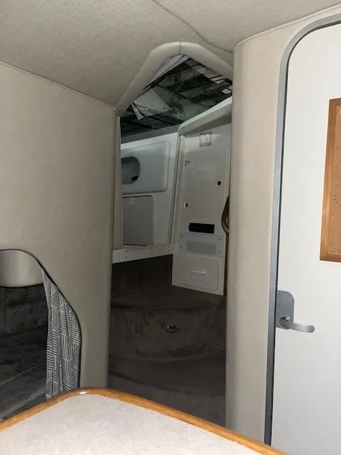 Slide: The Image of Interior cabin of 1996 Sea Ray 290 Sundancer boat, featuring seating and storage. - 20