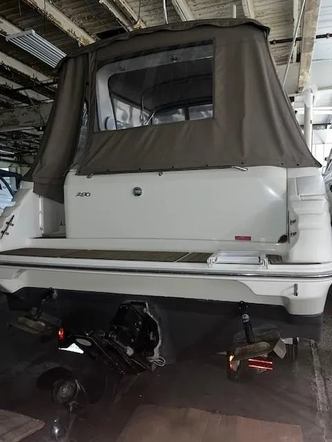 Slide: The Image of 1996 Sea Ray 290 Sundancer boat, rear view, in a covered storage area. - 3