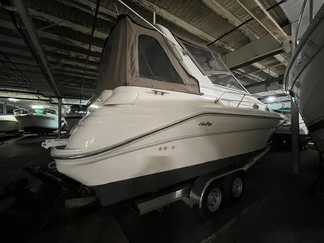Slide: The Image of 1996 Sea Ray 290 Sundancer boat on trailer in indoor storage facility. - 4