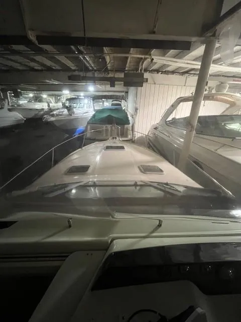 Slide: The Image of 1996 Sea Ray 290 Sundancer boat docked in a covered marina. - 5