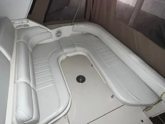 Slide: The Image of 1996 Sea Ray 290 Sundancer interior with white leather seating and cup holders. - 7