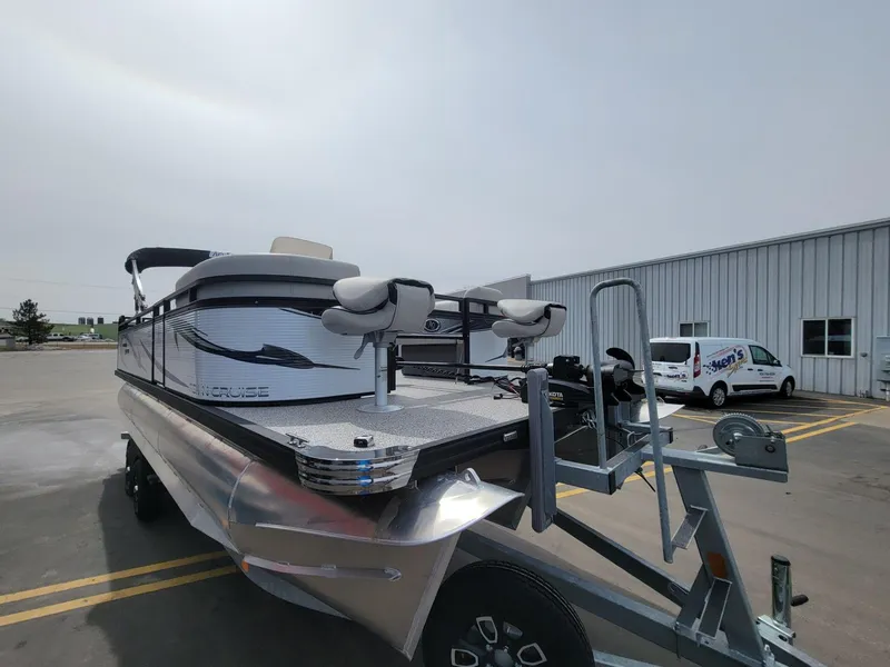 Slide: The Image of 2023 Angler Qwest 2285 Fish N Cruise pontoon boat on trailer in parking lot. - 11