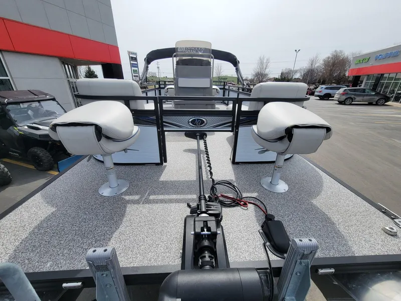 Slide: The Image of 2023 Angler Qwest 2285 Fish N Cruise pontoon boat with seating, parked outdoors. - 14