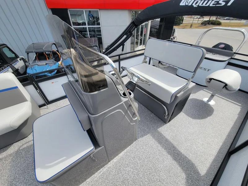 Slide: The Image of 2023 Angler Qwest 2285 Fish N Cruise boat interior with seating and steering console. - 22