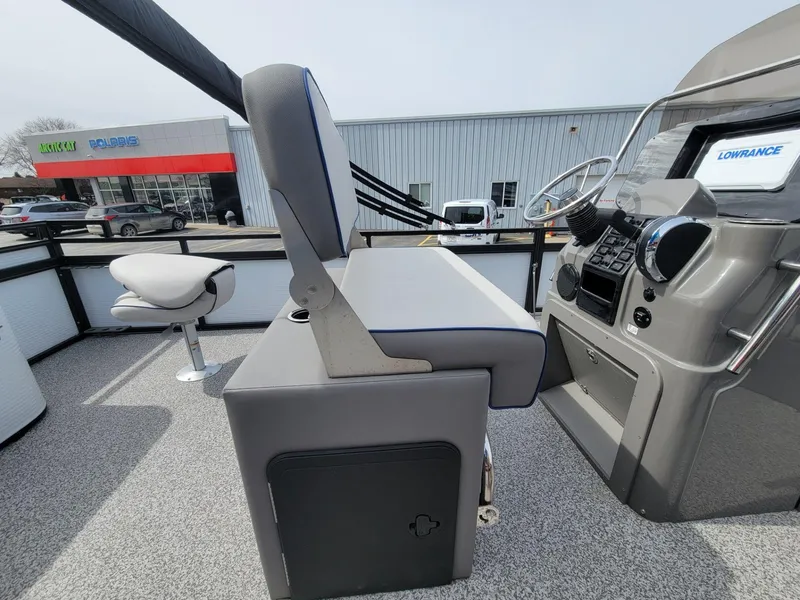 Slide: The Image of 2023 Angler Qwest 2285 Fish N Cruise boat interior with helm and seating. - 24