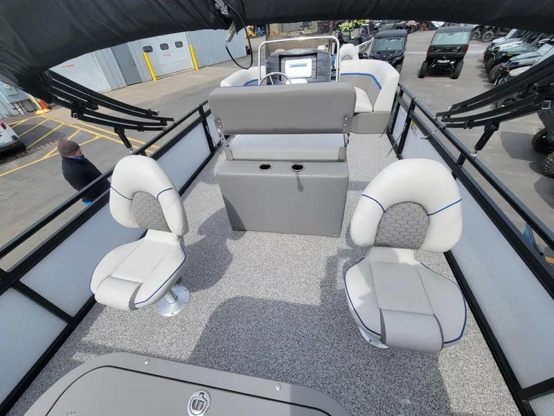 Slide: The Image of 2023 Angler Qwest 2285 Fish N Cruise interior with seating and console, parked outdoors. - 27