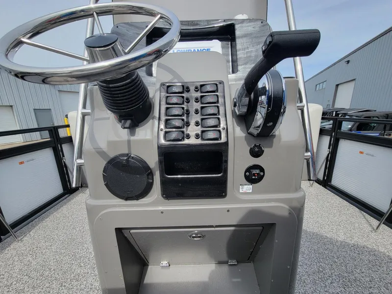 Slide: The Image of Control panel of 2023 Angler Qwest 2285 Fish N Cruise boat, featuring steering wheel and switches. - 28