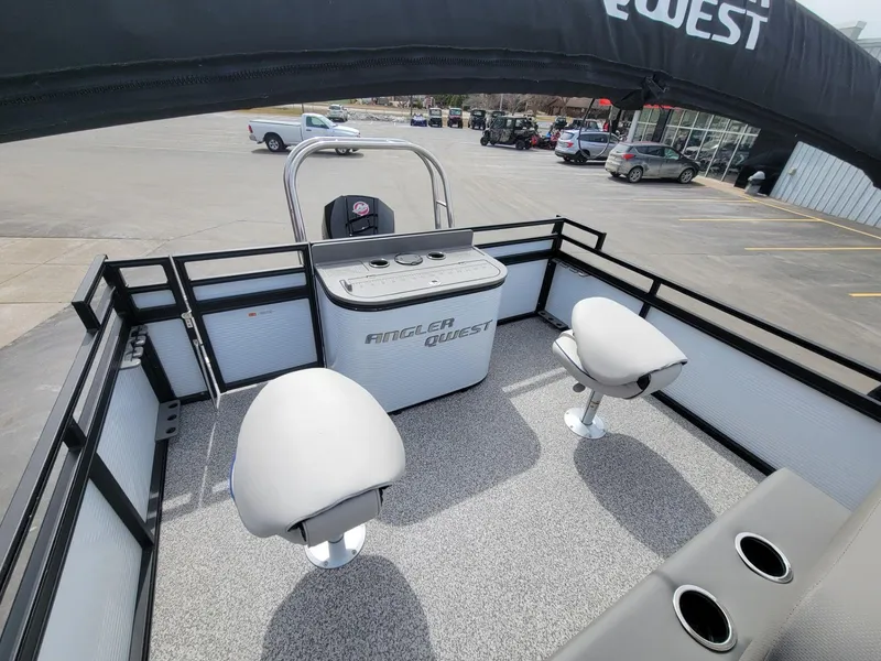 Slide: The Image of 2023 Angler Qwest 2285 Fish N Cruise boat interior with seating and control console. - 31