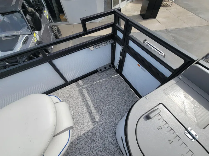 Slide: The Image of 2023 Angler Qwest 2285 Fish N Cruise boat interior with seating and storage compartments. - 35