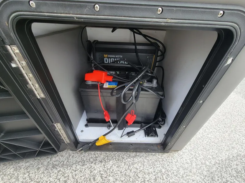 Slide: The Image of Battery compartment of 2023 Angler Qwest 2285 FISH N CRUISE with Minn Kota charger. - 38