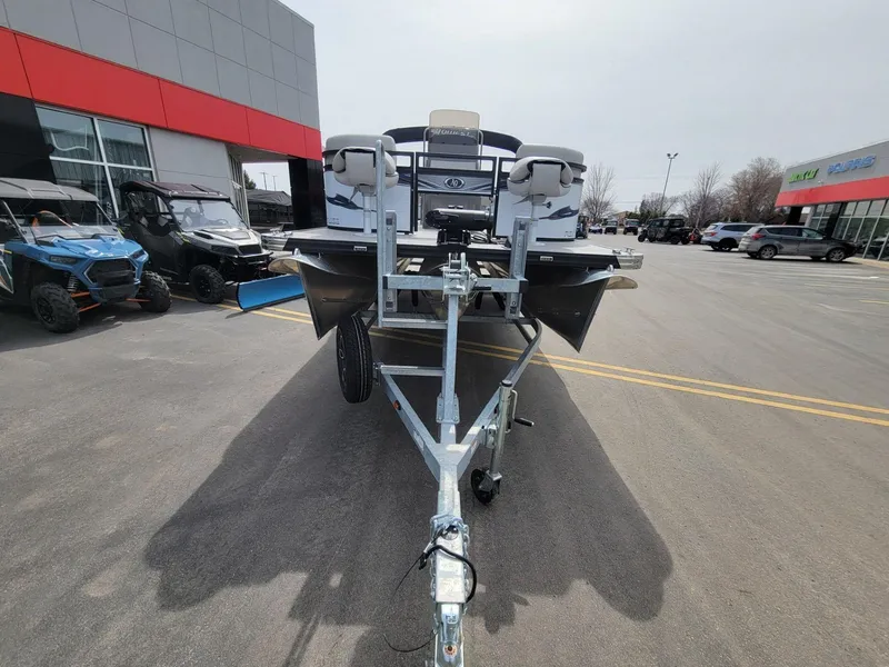 Slide: The Image of 2023 Angler Qwest 2285 Fish N Cruise boat on trailer in dealership lot. - 8