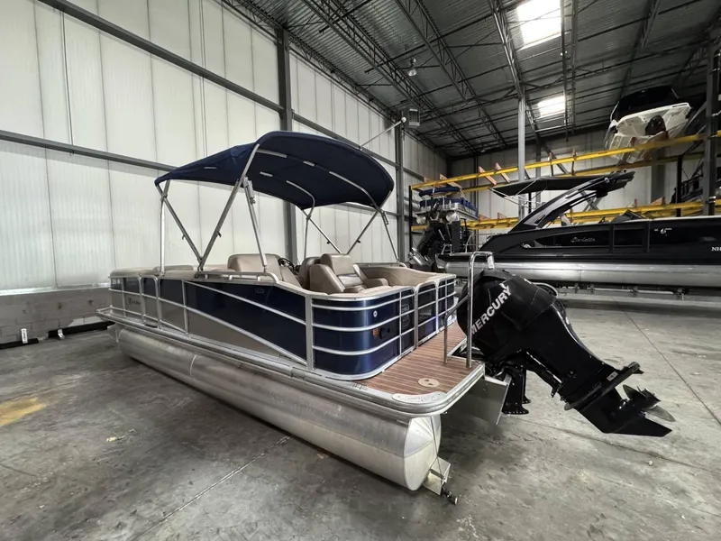 Slide: The Image of 2012 Berkshire 223SLX STS pontoon boat with Mercury engine in a warehouse. - 3