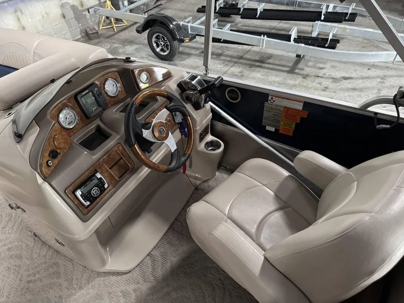 Slide: The Image of 2012 Berkshire 223SLX STS boat interior with steering wheel and control panel. - 7
