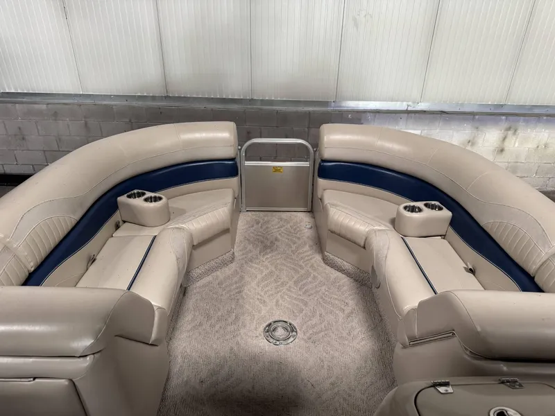 Slide: The Image of Interior of a 2012 Berkshire 223SLX STS pontoon boat with beige seating and cup holders. - 8