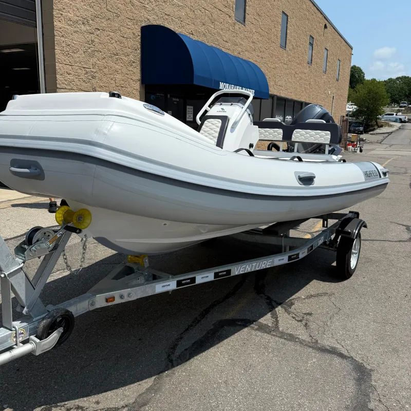 The Image of 2025 Highfield Sport 420 boat on trailer outside a building. - 1