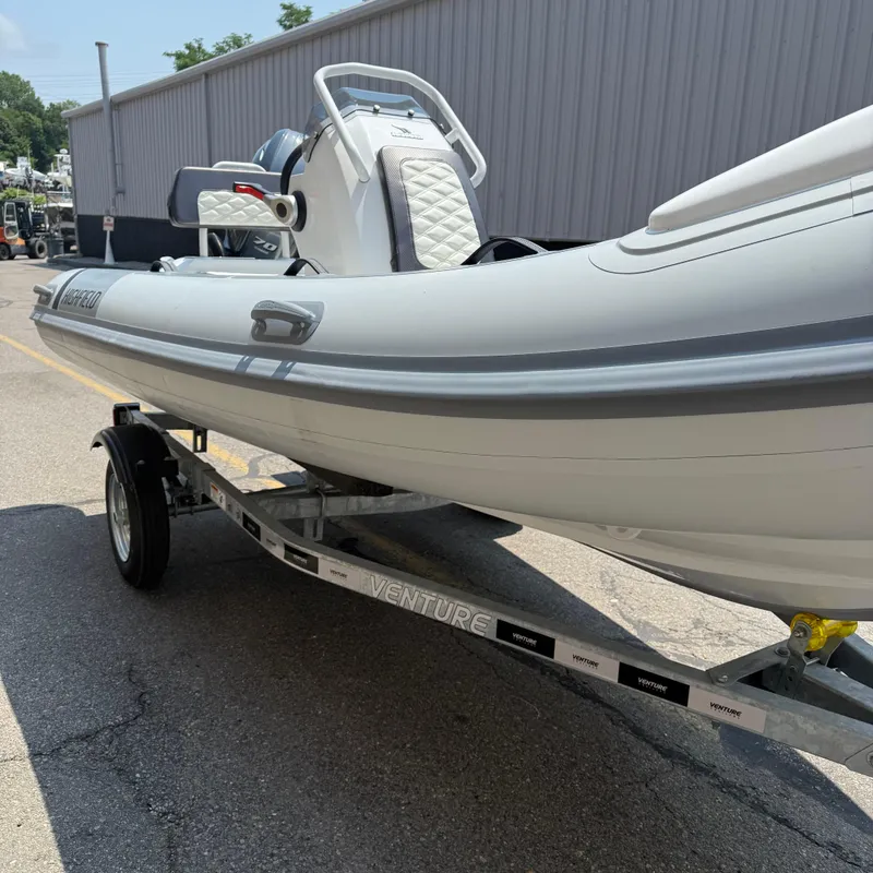 Slide: The Image of 2025 Highfield Sport 420 boat on trailer, parked outdoors. - 10
