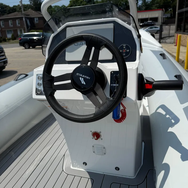 Slide: The Image of 2025 Highfield Sport 420 boat steering console with modern controls and sleek design. - 4