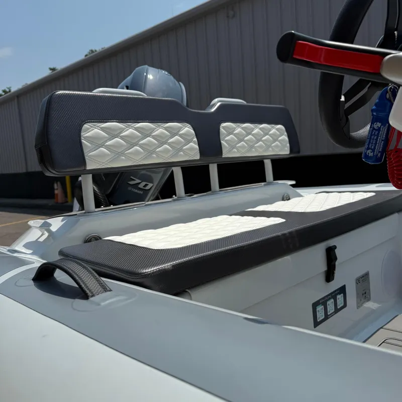 Slide: The Image of 2025 Highfield Sport 420 boat interior with cushioned seating and steering wheel. - 6