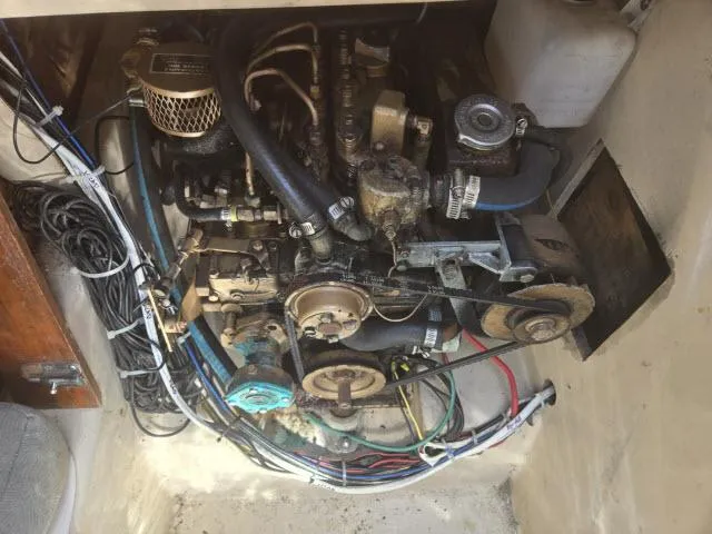 Slide: The Image of Engine compartment of a 1984 Newport 33 sailboat, showing mechanical components and wiring. - 10