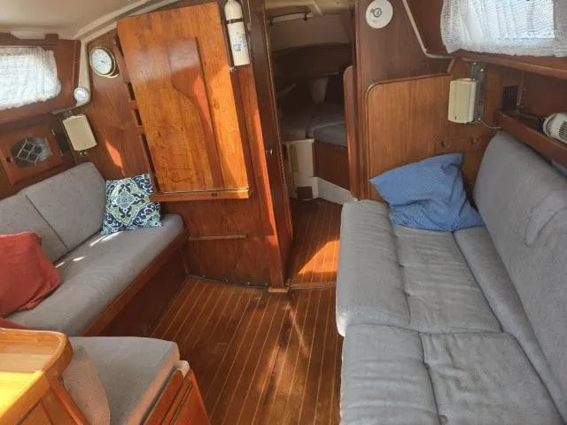 Slide: The Image of Interior of 1984 Newport 33 sailboat with wooden finish and cozy seating. - 2