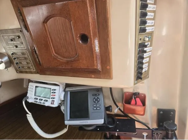 Slide: The Image of Control panel of a 1984 Newport 33 sailboat with navigation equipment and switches. - 5