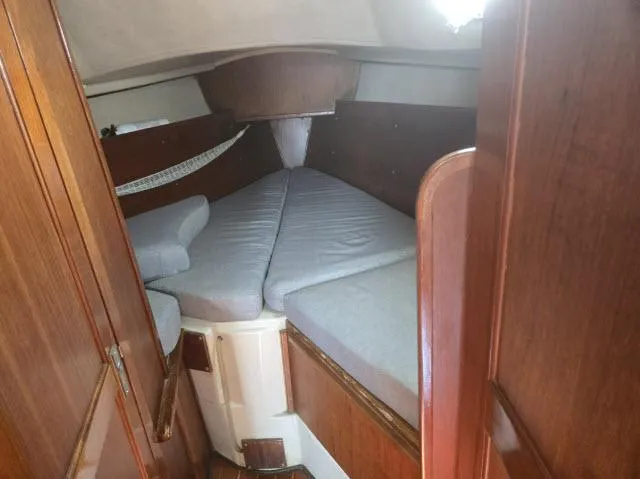 Slide: The Image of Interior cabin of 1984 Newport 33 sailboat with wooden finish and V-berth. - 6